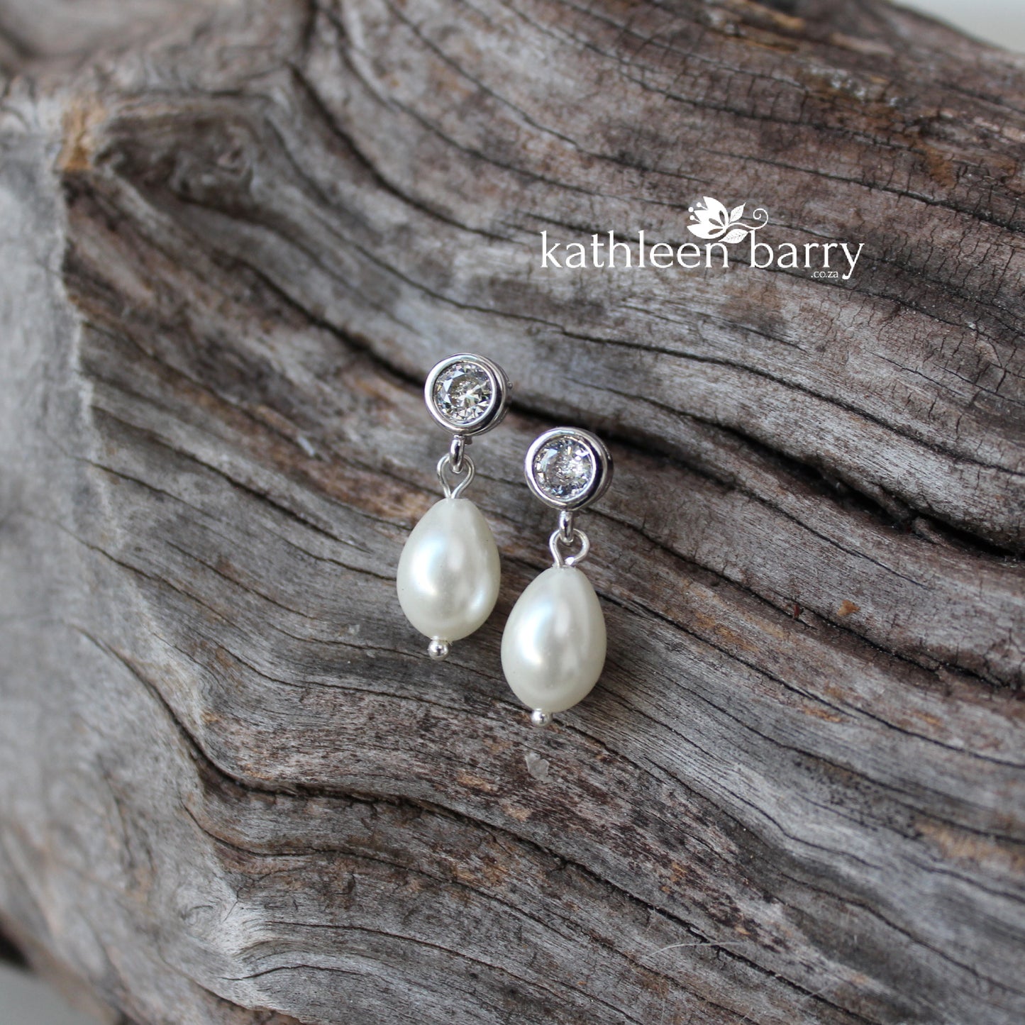 Simple pearl drop cubic zirconia stud earrings available in Silver finish only