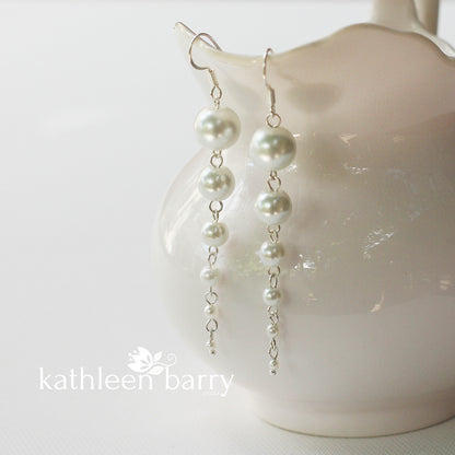 Pearl drop earrings grading in size from big to small cascading pearls