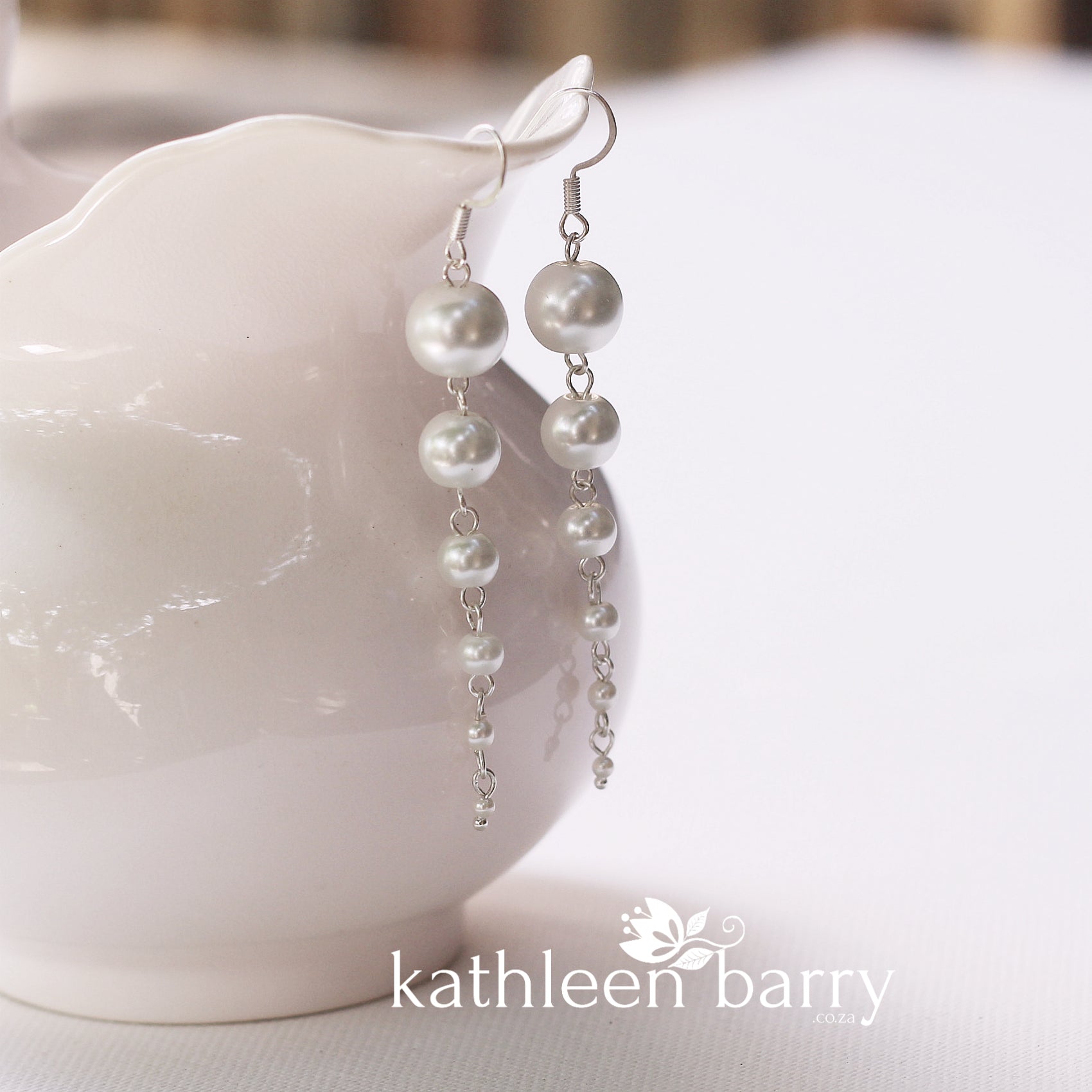 Pearl drop earrings grading in size from big to small cascading pearls