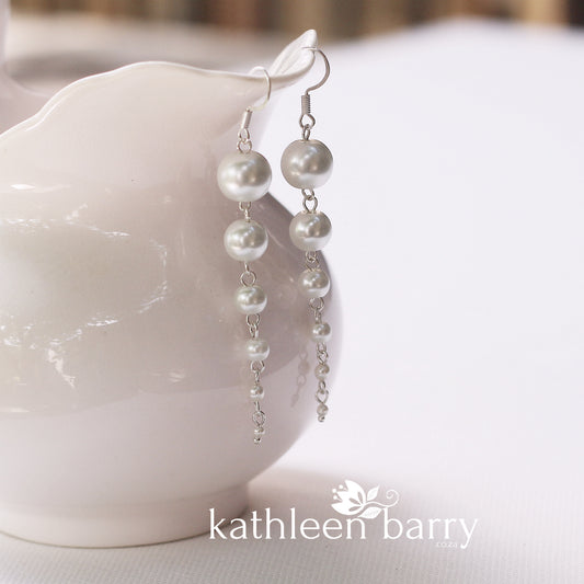 Pearl drop earrings grading in size from big to small cascading pearls
